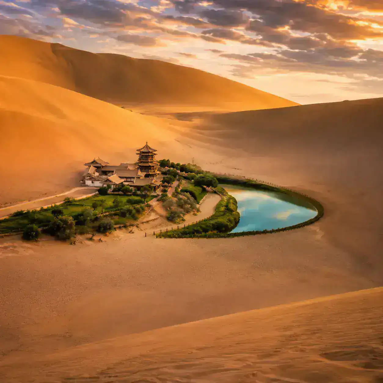 Crescent Lake oasis surrounded by the Singing Sand Dunes in Dunhuang