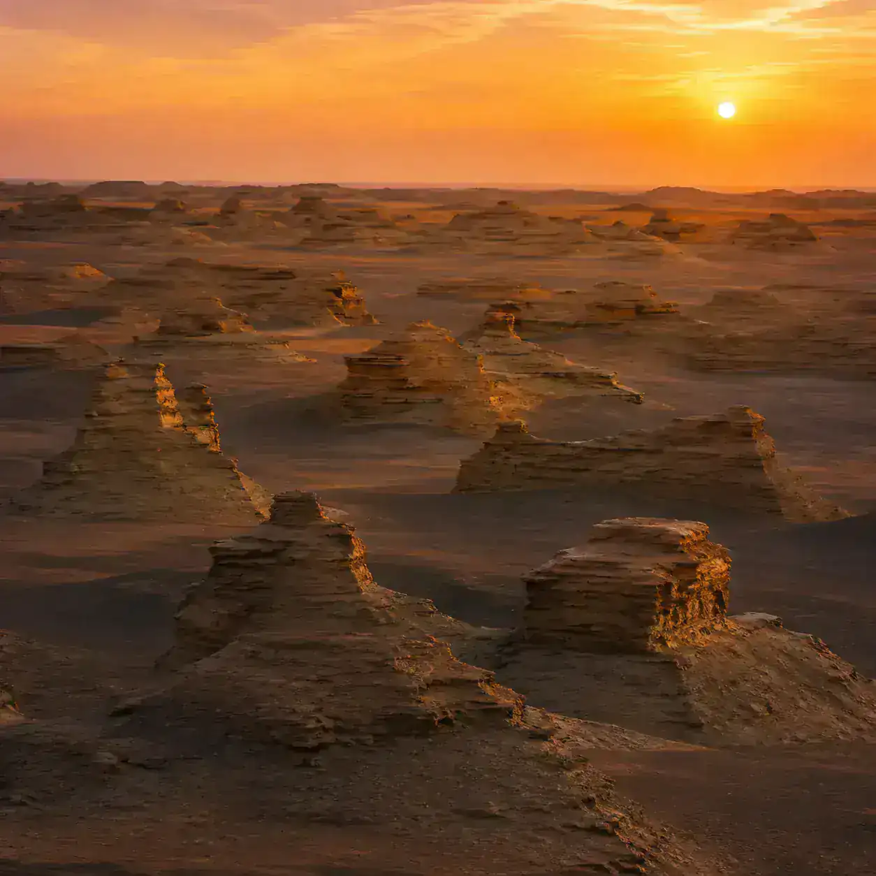 Wind-carved yardang rock formations of Yadan Geopark at sunset
